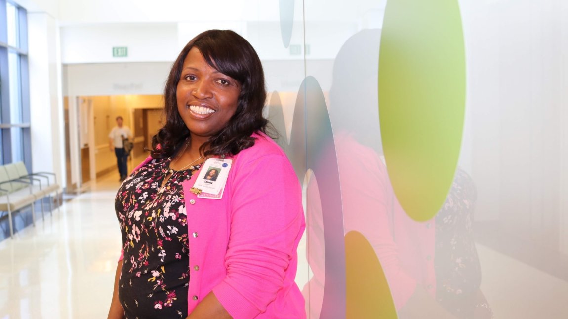Smiling black female nurse Tammy Turner in hospital hallway
